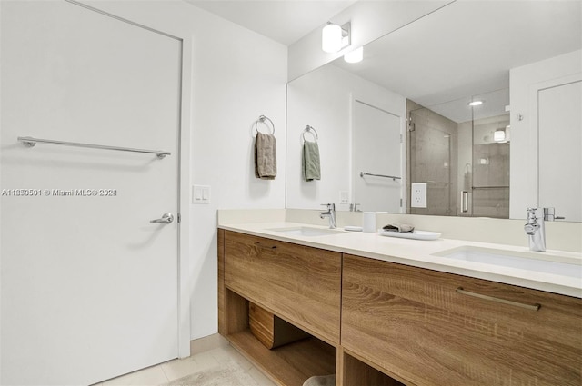 bathroom with tile patterned floors, a shower with door, and vanity