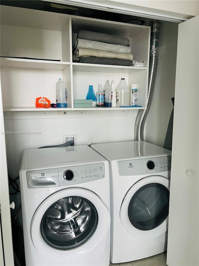 laundry area with washing machine and clothes dryer