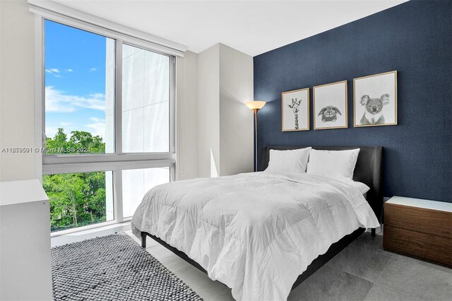 16385 Biscayne Blvd Unit 421, North Miami Beach, FL 33160 - bedroom featuring an accent wall