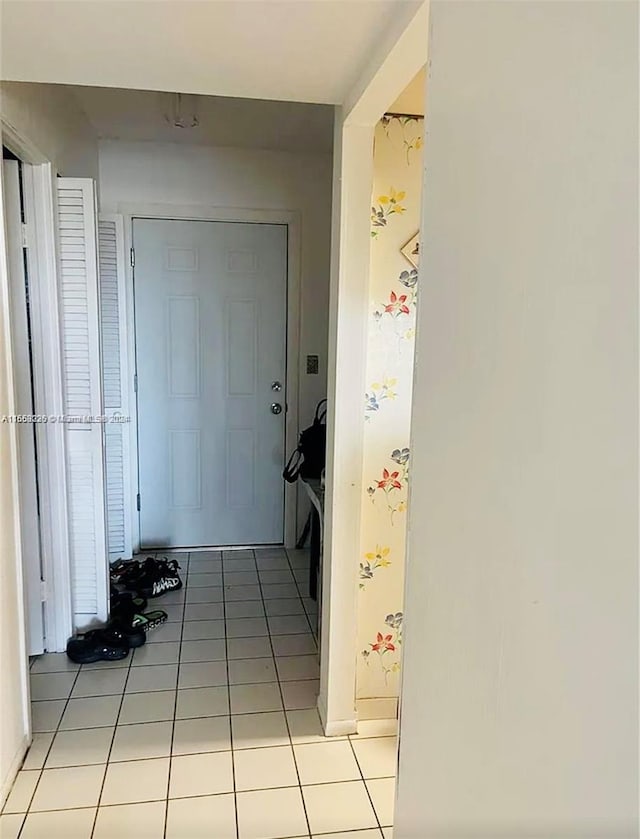 hall with light tile patterned floors