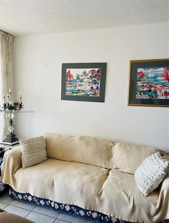 living room with a textured ceiling and tile patterned floors