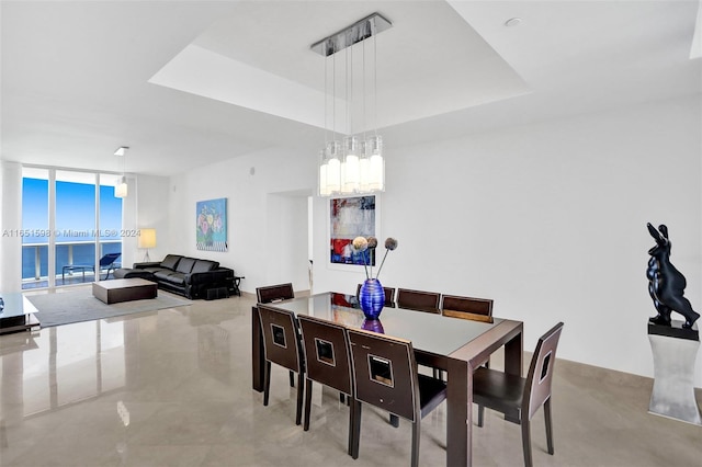 dining room featuring expansive windows and a water view