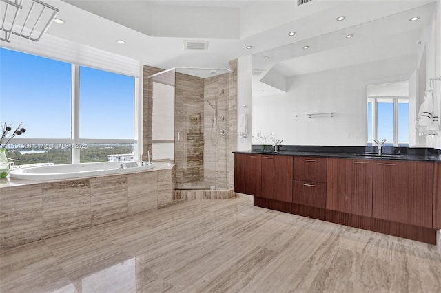 bathroom featuring vanity and plus walk in shower