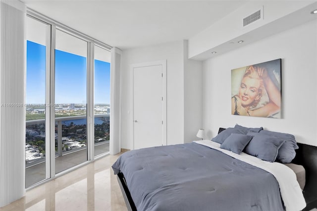 bedroom featuring a wall of windows and access to exterior