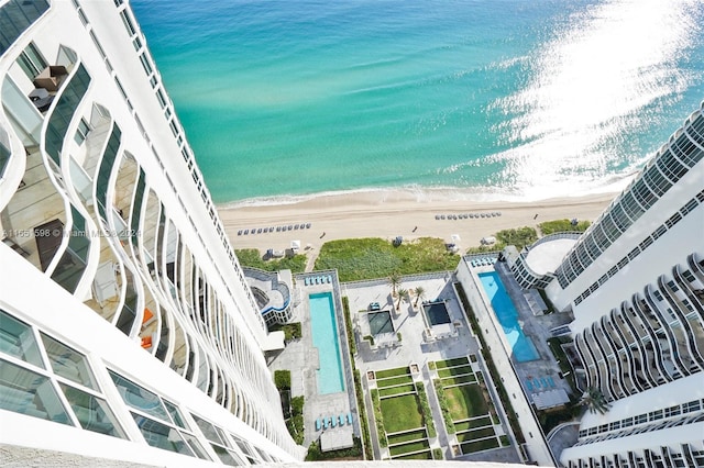 bird's eye view with a water view and a beach view