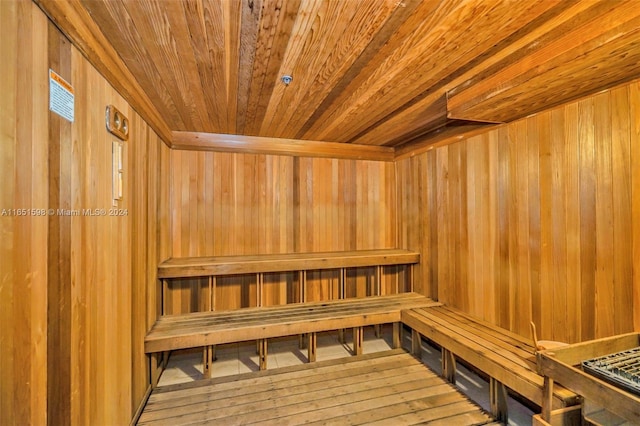 view of sauna featuring hardwood / wood-style flooring, wood ceiling, and wood walls