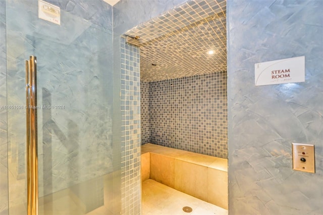 bathroom with tile walls and a tile shower