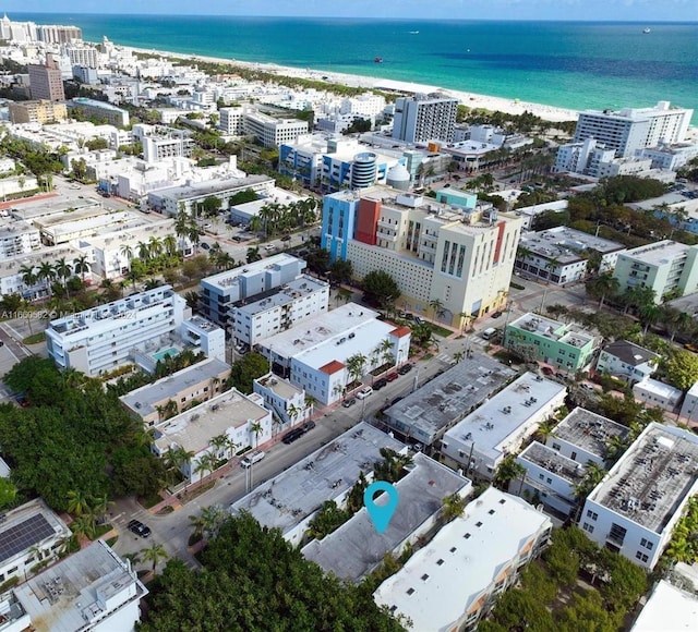 drone / aerial view with a beach view and a water view