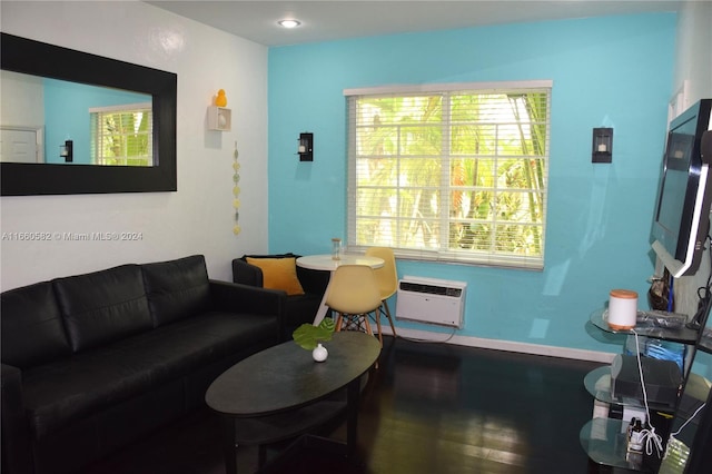 living room featuring an AC wall unit and hardwood / wood-style flooring