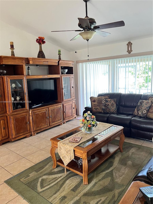 tiled living room featuring ceiling fan and vaulted ceiling