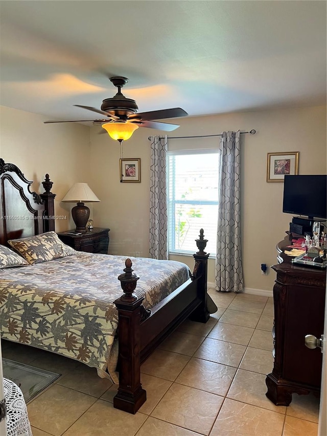 tiled bedroom featuring ceiling fan