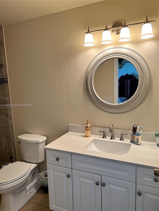 bathroom featuring tile patterned flooring, vanity, and toilet