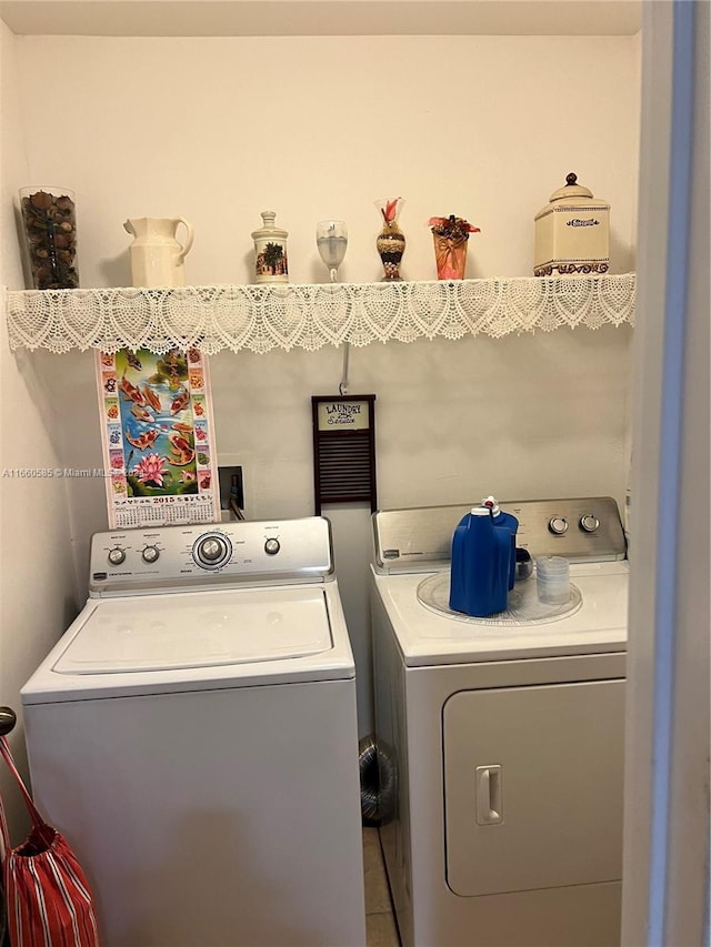 washroom with separate washer and dryer and tile patterned flooring