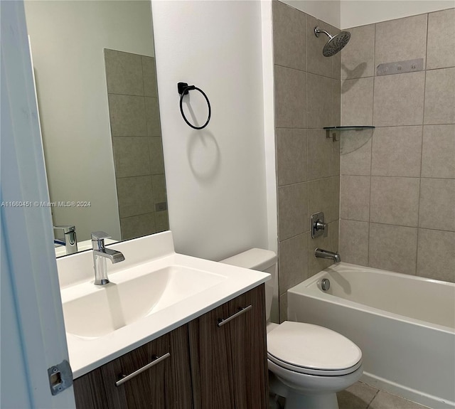 full bathroom featuring tile patterned flooring, vanity, toilet, and tiled shower / bath combo