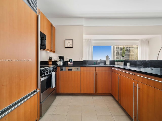 kitchen with sink, light tile patterned floors, electric range, dishwashing machine, and dark stone countertops