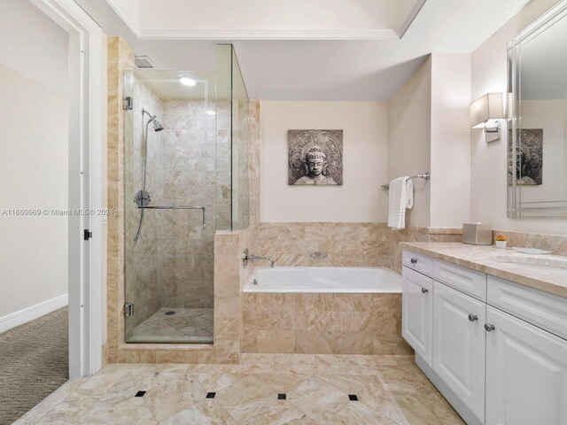 bathroom featuring ornamental molding, independent shower and bath, and vanity