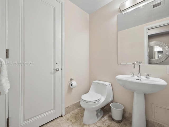 1435 Brickell Ave Unit 3212, Miami, FL 33131 - half bathroom featuring baseboards, visible vents, toilet, and tile patterned flooring