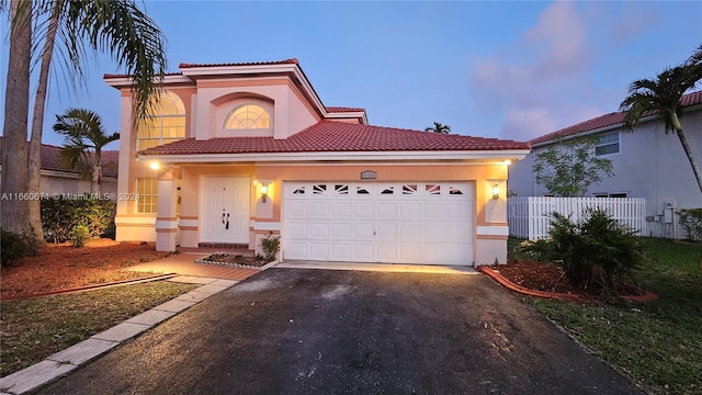 mediterranean / spanish house featuring a garage