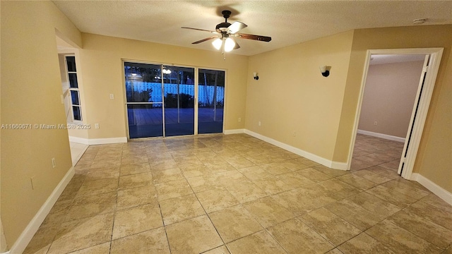 unfurnished room with tile patterned floors, baseboards, a textured ceiling, and ceiling fan