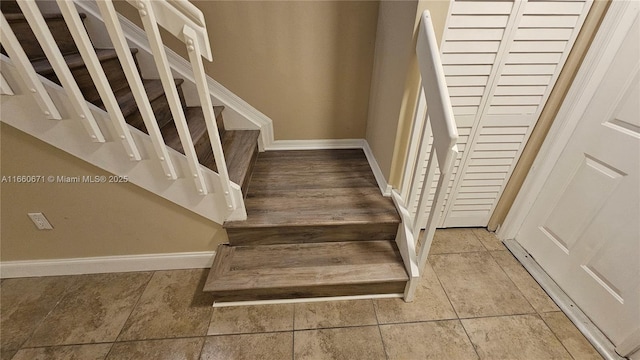 staircase with tile patterned flooring and baseboards