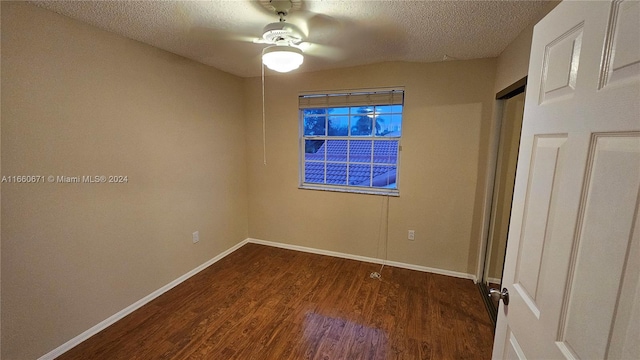 unfurnished bedroom featuring a textured ceiling, dark wood-type flooring, and ceiling fan