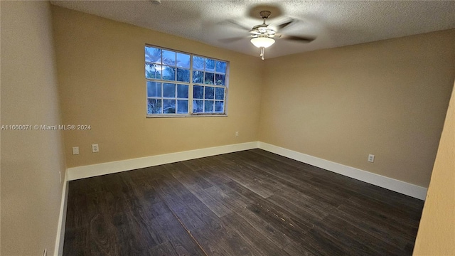 spare room featuring ceiling fan, a textured ceiling, and dark wood-type flooring