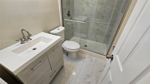 bathroom with vanity, a shower with shower door, and toilet