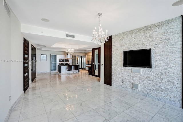 interior space featuring a notable chandelier and a tray ceiling