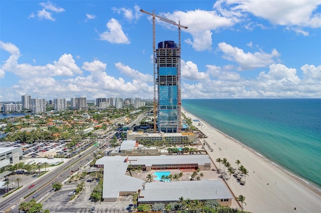 birds eye view of property featuring a view of the beach and a water view