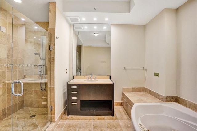 bathroom with vanity and shower with separate bathtub