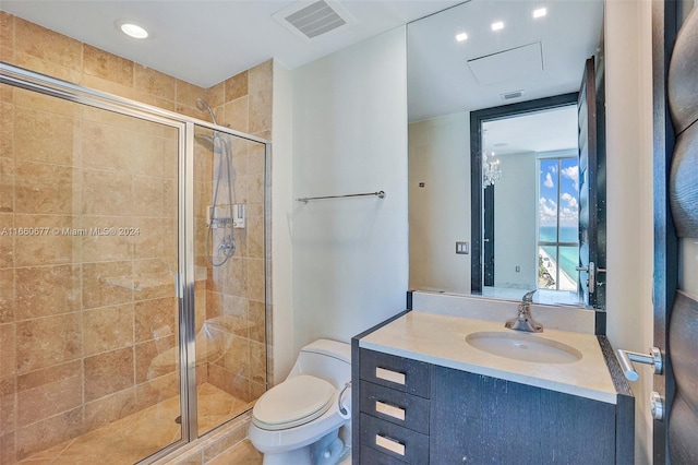 bathroom featuring vanity, toilet, and a shower with door