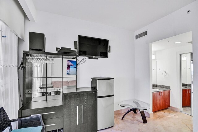 kitchen with stainless steel refrigerator and light tile patterned floors