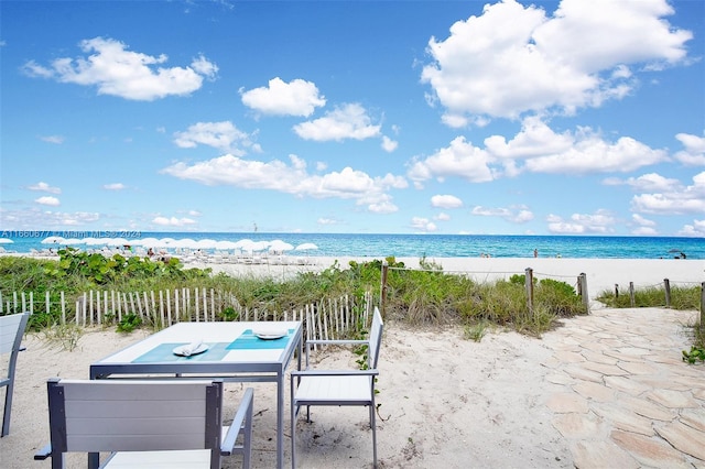 view of patio / terrace with a view of the beach and a water view