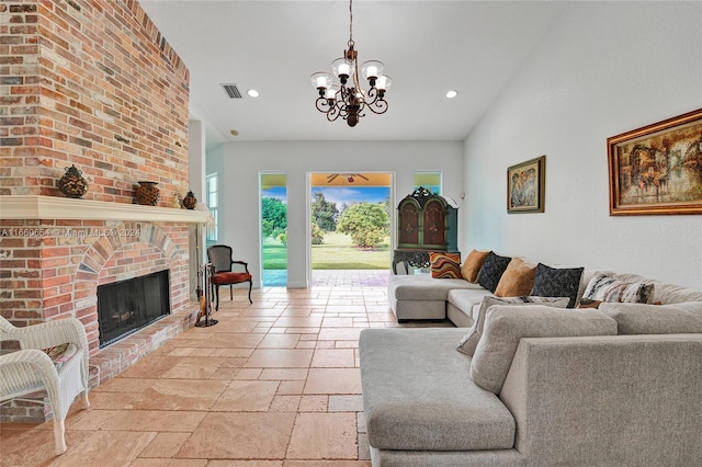 living room with an inviting chandelier and a brick fireplace