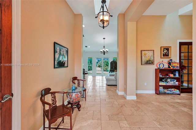 corridor with a notable chandelier and french doors