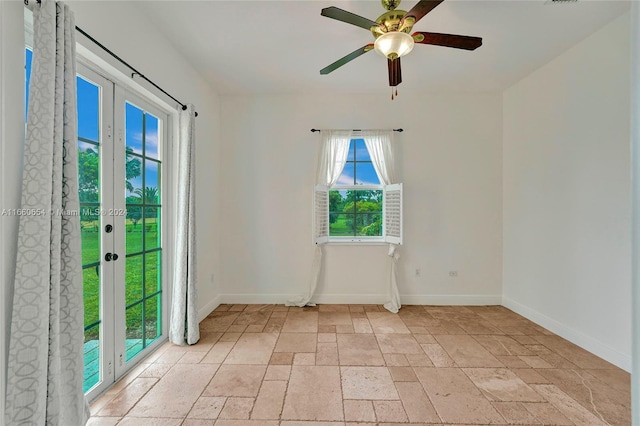 empty room with french doors and ceiling fan