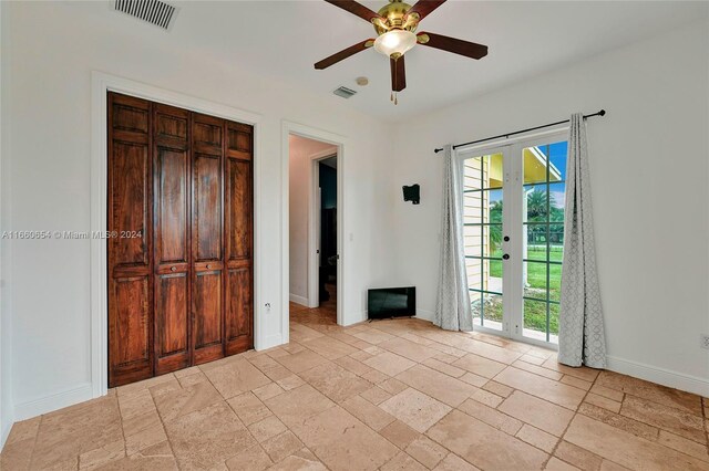 interior space featuring ceiling fan and french doors