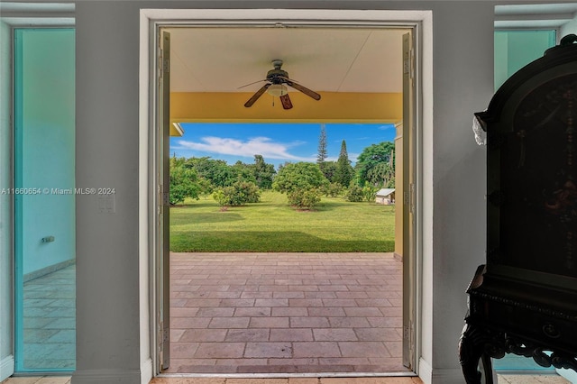 doorway with ceiling fan