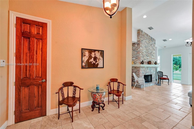 living area featuring lofted ceiling and a fireplace