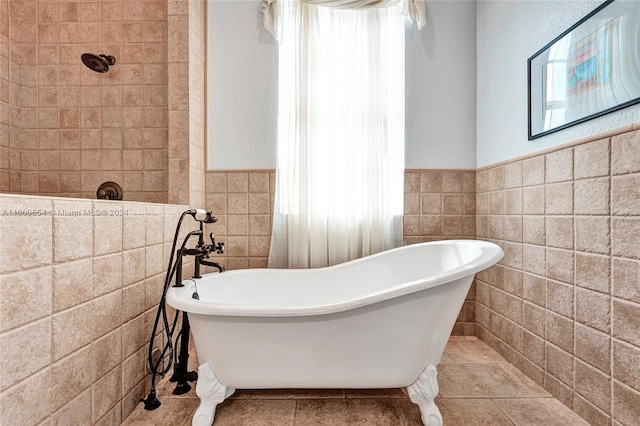 bathroom with tile patterned floors, tile walls, and a tub