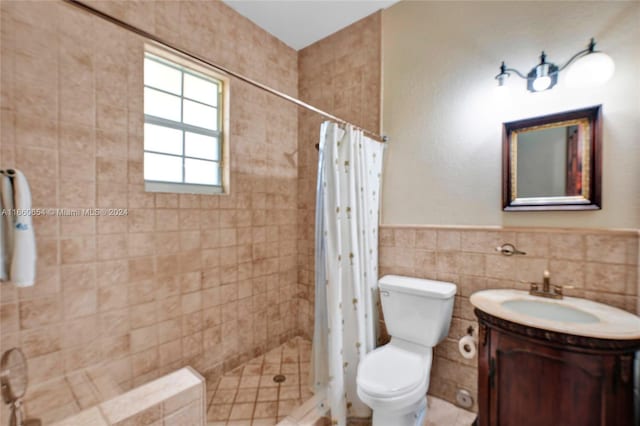 bathroom with a shower with shower curtain, vanity, toilet, and tile walls