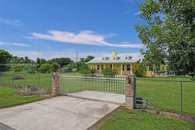 view of gate featuring a yard