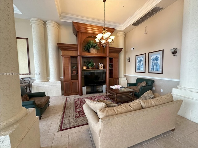 living room with light tile patterned floors, ornamental molding, an inviting chandelier, and ornate columns