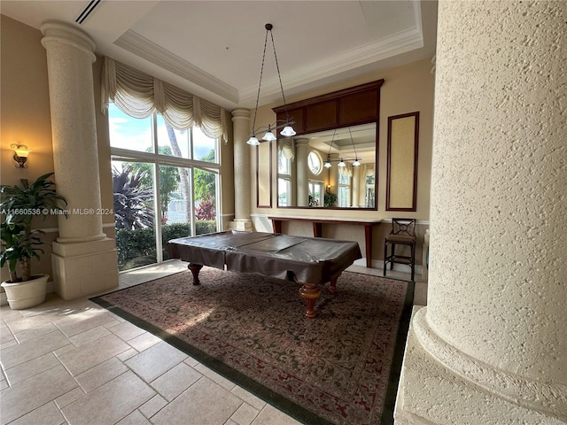 dining area with crown molding, a raised ceiling, billiards, and ornate columns