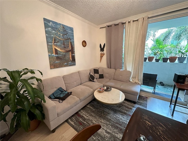 living room featuring a textured ceiling, ornamental molding, and hardwood / wood-style floors