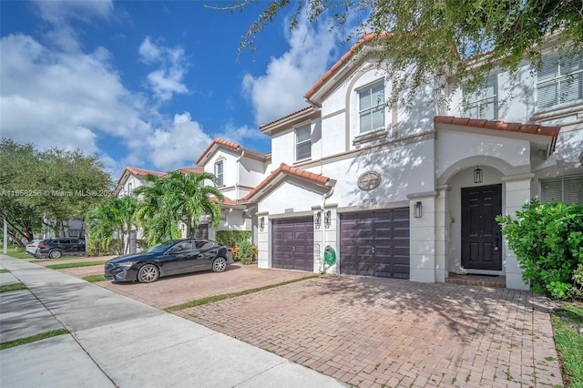 mediterranean / spanish-style house with a garage