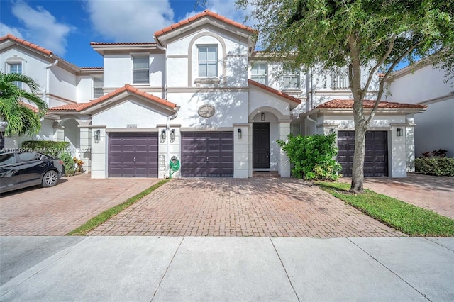 mediterranean / spanish home with a garage