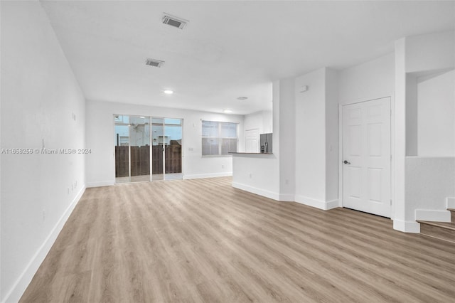 unfurnished living room with light wood-type flooring