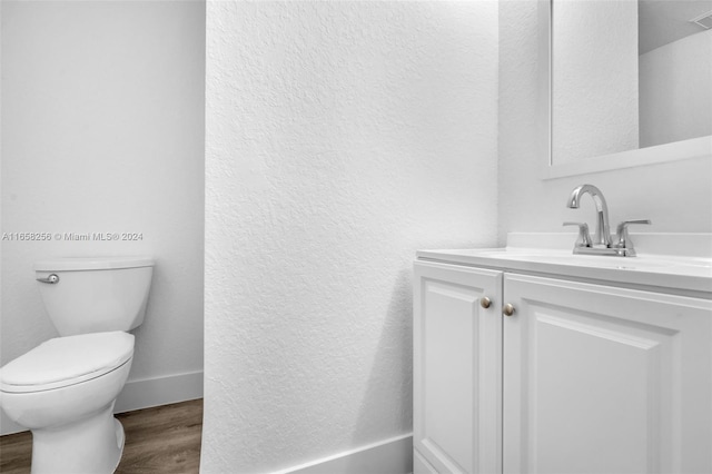 bathroom featuring vanity, toilet, and wood-type flooring