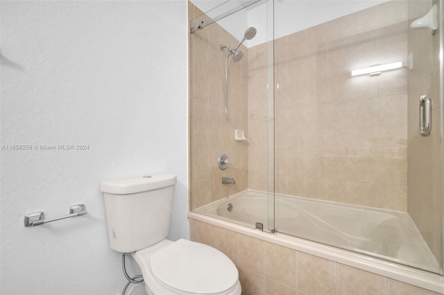 bathroom featuring toilet and enclosed tub / shower combo